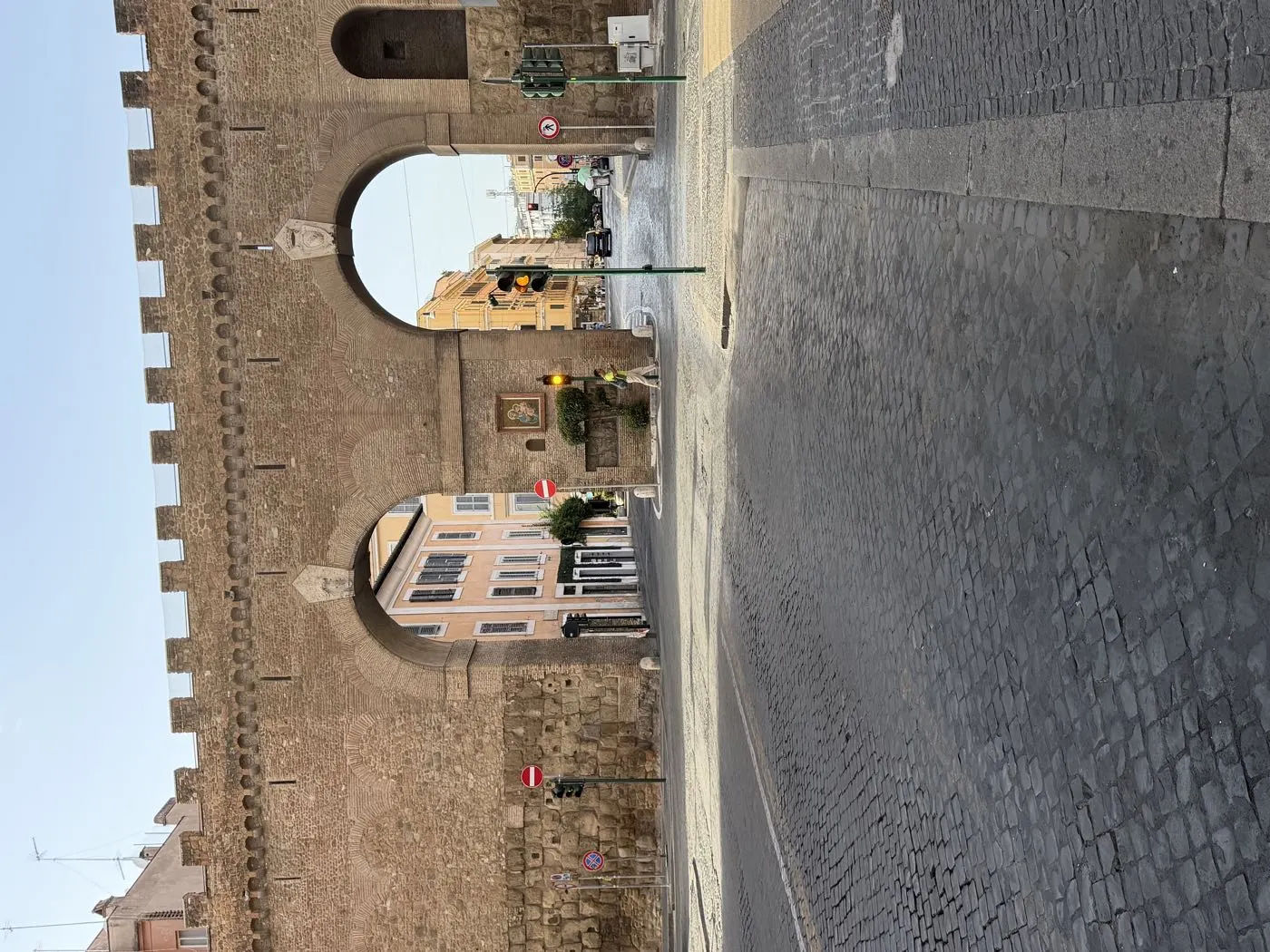 Rome&rsquo;s ancient walls and an empty cobbled street shortly after sunrise